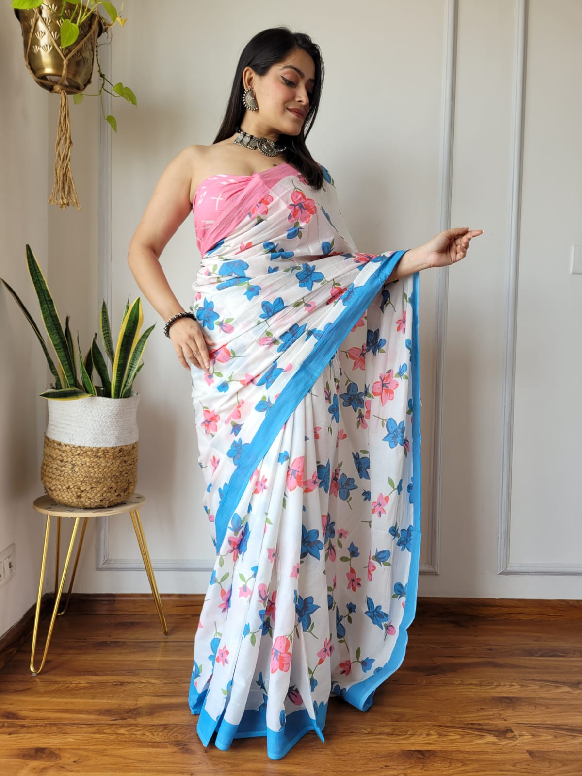 Caption: Pure Grace: White Mulcotton Saree with Floral Prints